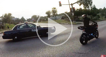 COP SWERVES AT MOTORCYCLE STUNT RIDERS